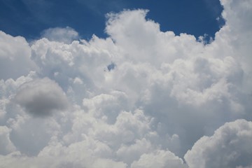 Naklejka na ściany i meble Fluffy Billowy Cumulus Clouds in the Blue Summer Sky in Florida