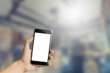 Hand hold on mobile with coffee shop background