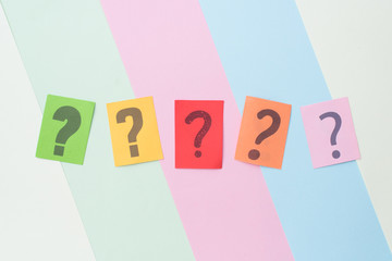colorful paper with QUESTION MARK on multicolored pastel color background. FAQ,Q&A,Mystery and questions concept