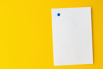 Empty white sheet is pinned to a yellow background