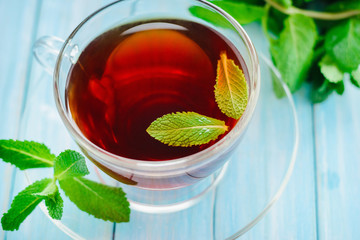lass cup of black tea or fresh mint leaves © Lazy_Bear