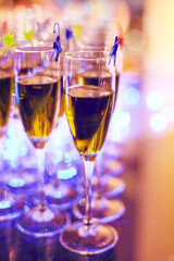 a row of glasses filled with champagne are lined up