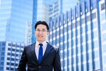 Fototapeta premium The asian businessman has thinking of vision with building and city background.