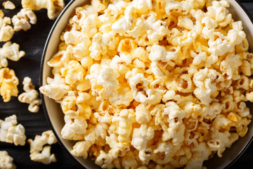 Tasty popcorn with cheese cheddar and parmesan in a bowl macro. horizontal top view