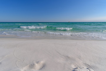 Gulf of Mexico emerald green and blue water washing on shore in waves