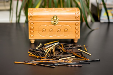 Invisibles (hairpins)near the closed box on table in the hairdressing salon to create  stylish hairstyle_
