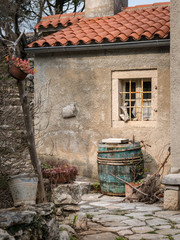 Wine barrel in front of an old house in Valun