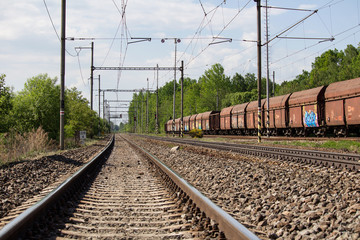 Fototapeta na wymiar Railway track with old wagons parking on railway yard