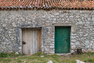 Stone house with two old wooden doors