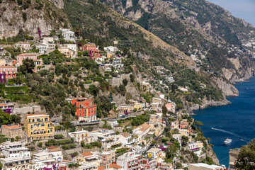 Fototapeta na wymiar Colourful Positano, the jewel of the Amalfi Coast, with its multicoloured homes and buildings perched on a large hill overlooking the sea. Italy