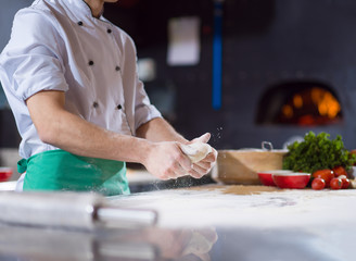 chef hands preparing dough for pizza