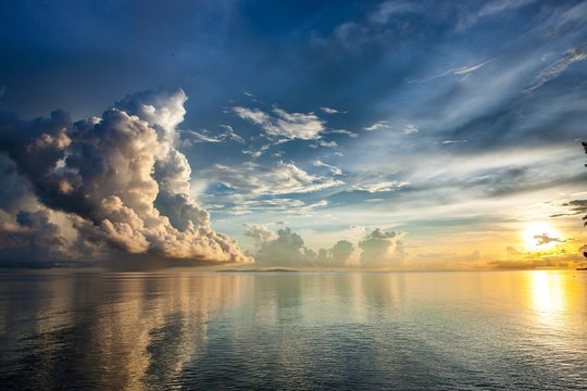 Majestic oceanic sunrise above Sulu sea. Stunning view over Pacific ocean sunrise. Beautiful dramatic clouds ocean sunrise. Sunrise above ocean horizon. Version 2.