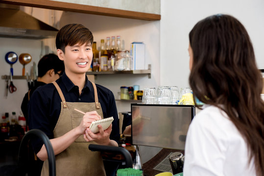 Asian Man Staff Taking Order From The Customer In Coffee Shop