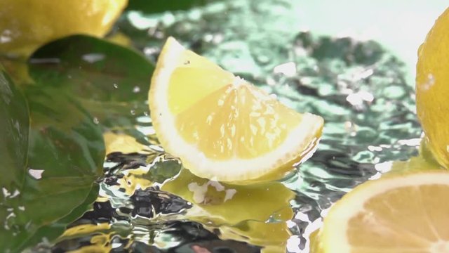 Lemon slice hits on fresh water surface . Slow motion shot
