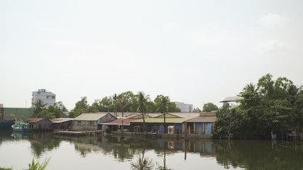 Obraz premium Houses along the coast. Houses on the banks of the river in Vietnam