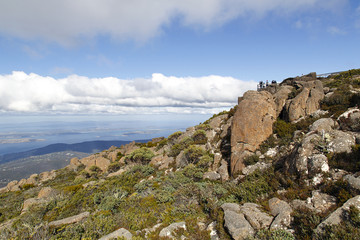 Fototapeta na wymiar Tourists enjoy the view of Hobart from the observation point on the summit of Mount Wellington in Tasmania