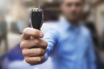 Car Keys. The hand of man presents the keys.