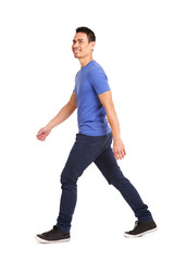 Happy asian man walking over white