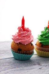 Tasty cupcakes on wooden background. Birthday cupcake in rainbow colors