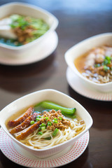 Bowls of pork noodle soup on the table
