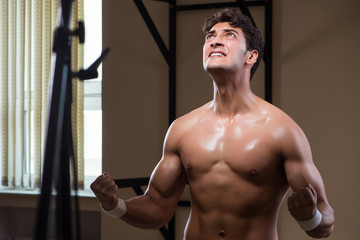 Fototapeta na wymiar Ripped muscular man in gym doing sports