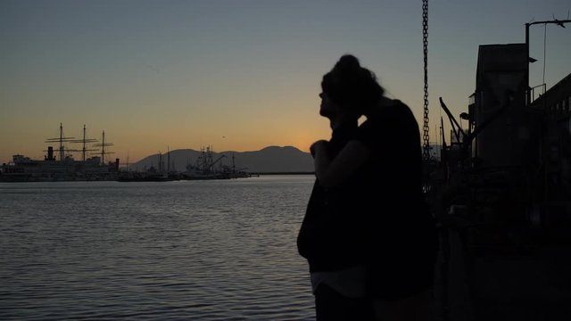 A couple in love embracing while watching a sunset in San Francisco.