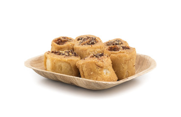 Indian Fried Bhakarwadi Tea Time Snack also known as bakarwadi, bakarvadi, bakar vadi, bakar wadi or spring roll is a traditional spicy Maharashtra and Gujarat Snack isolated on White Background