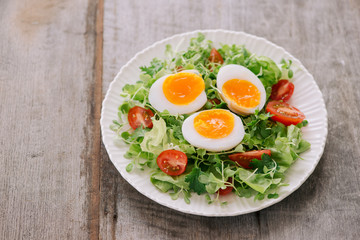 Lambs lettuce salad, hard-boiled eggs, tomatoes and honey mustard dressing
