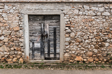 Very old weathered small door made of wood