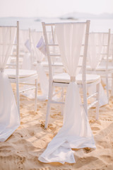 Fototapeta na wymiar Chairs on the beach at the wedding ceremony
