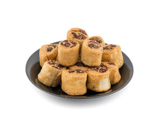 Indian Fried Bhakarwadi Tea Time Snack also known as bakarwadi, bakarvadi, bakar vadi, bakar wadi or spring roll is a traditional spicy Maharashtra and Gujarat Snack isolated on White Background
