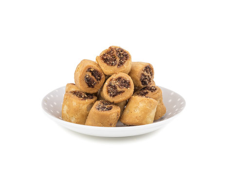 Indian Fried Bhakarwadi Tea Time Snack also known as bakarwadi, bakarvadi, bakar vadi, bakar wadi or spring roll is a traditional spicy Maharashtra and Gujarat Snack isolated on White Background