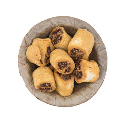 Indian Fried Bhakarwadi Tea Time Snack also known as bakarwadi, bakarvadi, bakar vadi, bakar wadi or spring roll is a traditional spicy Maharashtra and Gujarat Snack isolated on White Background