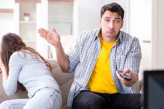 Pair watching tv at home