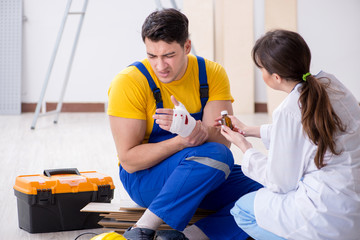 Injured worker being assisted by doctor