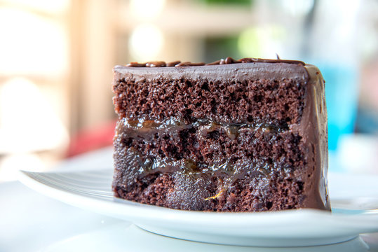 Delicious chocolate cake on White plate in cafe.
