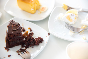 Dirty plate Empty dishes fter eating a cake on a white table.
