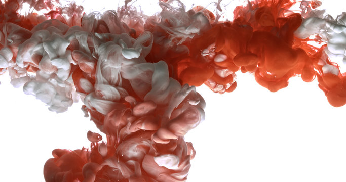 Red and white acrylic paint cloud spraying in water on white background.