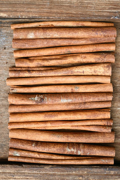 close up of cinnamon sticks on wooden background