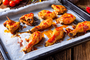Rustic backed chicken wings,legs on baking tray