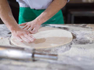 Fototapeta na wymiar chef preparing dough for pizza
