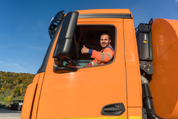 Waste collector driving 
Garbage truck giving thumbs up from the window
