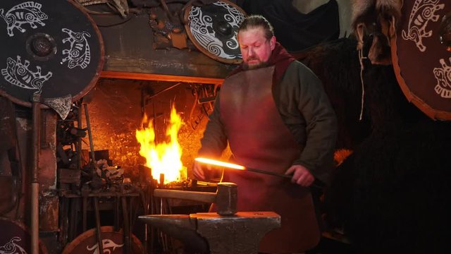 The smith viking working hard in a smithy