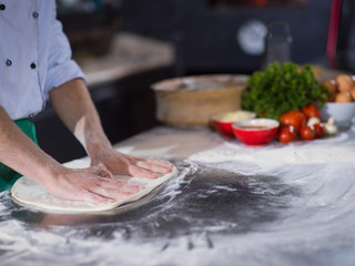 chef preparing dough for pizza