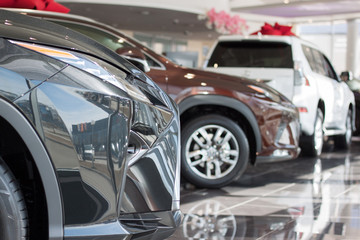 Obraz na płótnie Canvas Car auto dealership.Themed blur background with bokeh effect. New cars at dealer showroom.