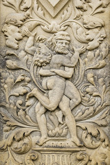 a sand stone relief of two men fighting