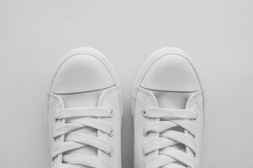 Pair of white sneakers with copy space