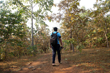 Asian men travel photograph nature. Travel relax. Walk on the path. Nature Study in the Jungle. 