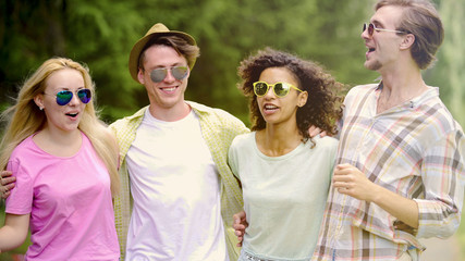 Multi-ethnic group of friends having fun and relaxing in park, vacation, meeting