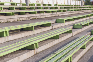 Fototapeta na wymiar Old benches at the stadium
